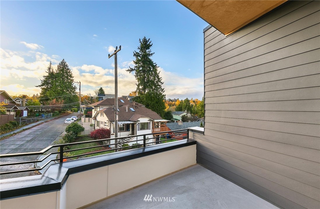 5200 Renton Avenue South Seattle, WA 98118 - Photo 21 of 21 a view of a balcony with two chairs and a potted plant on a street
