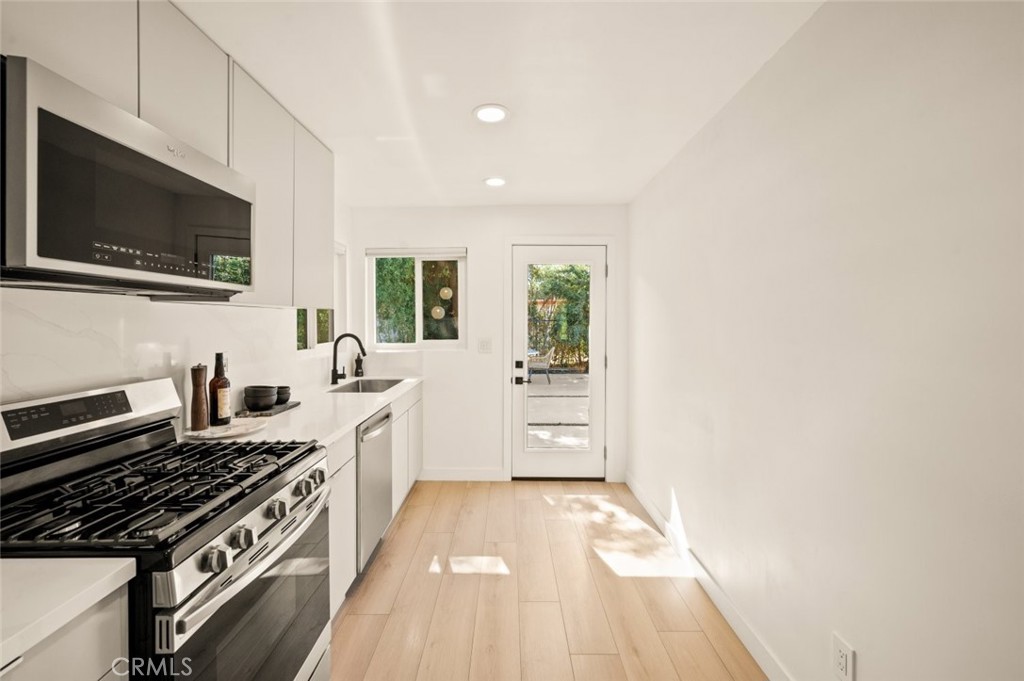 80890 Highway 111 Indio, CA 92201 - Photo 24 of 39 a kitchen with stainless steel appliances a stove microwave and sink