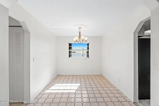 a view of an empty room and wooden floor