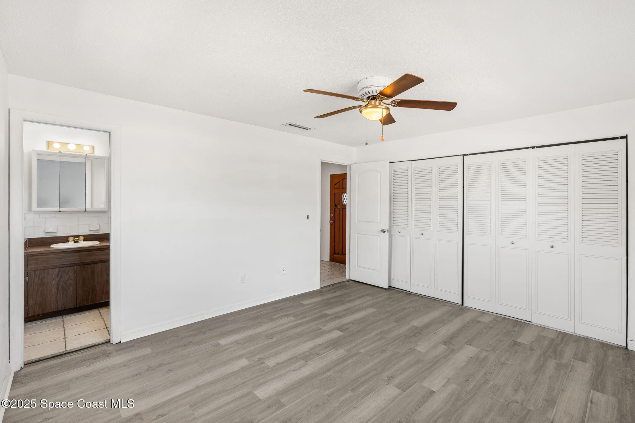 2361 Colony Drive Melbourne, FL 32935 - Photo 15 of 40 a view of a ceiling fan and a stove in a room