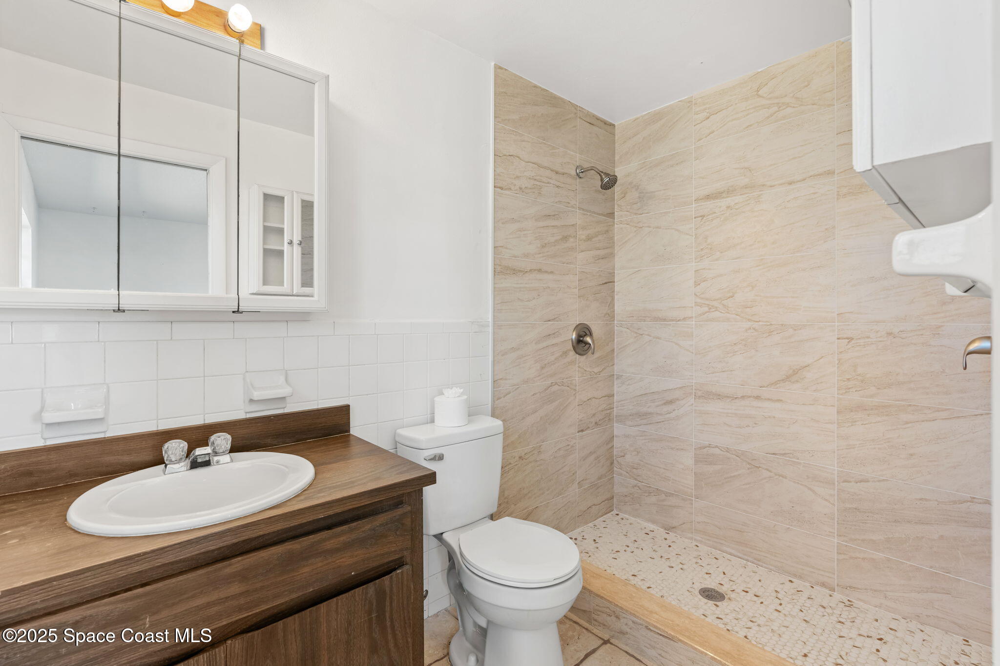 2361 Colony Drive Melbourne, FL 32935 - Photo 17 of 40 a bathroom with a sink toilet and shower