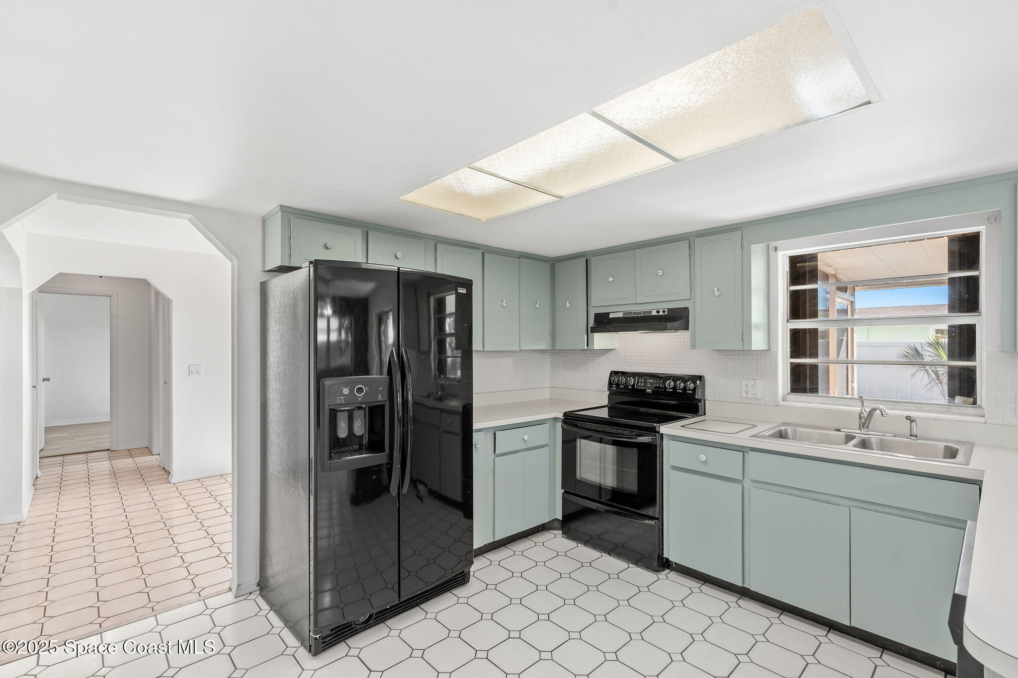 2361 Colony Drive Melbourne, FL 32935 - Photo 23 of 40 a kitchen with a sink stainless steel appliances and cabinets