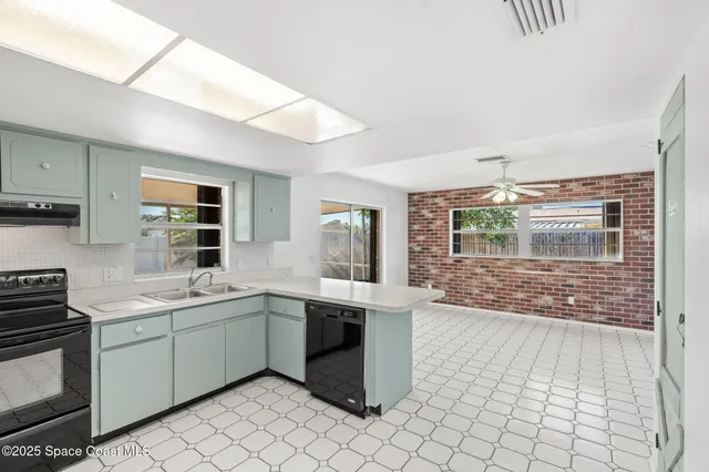 a view of a large room with wooden floor and windows
