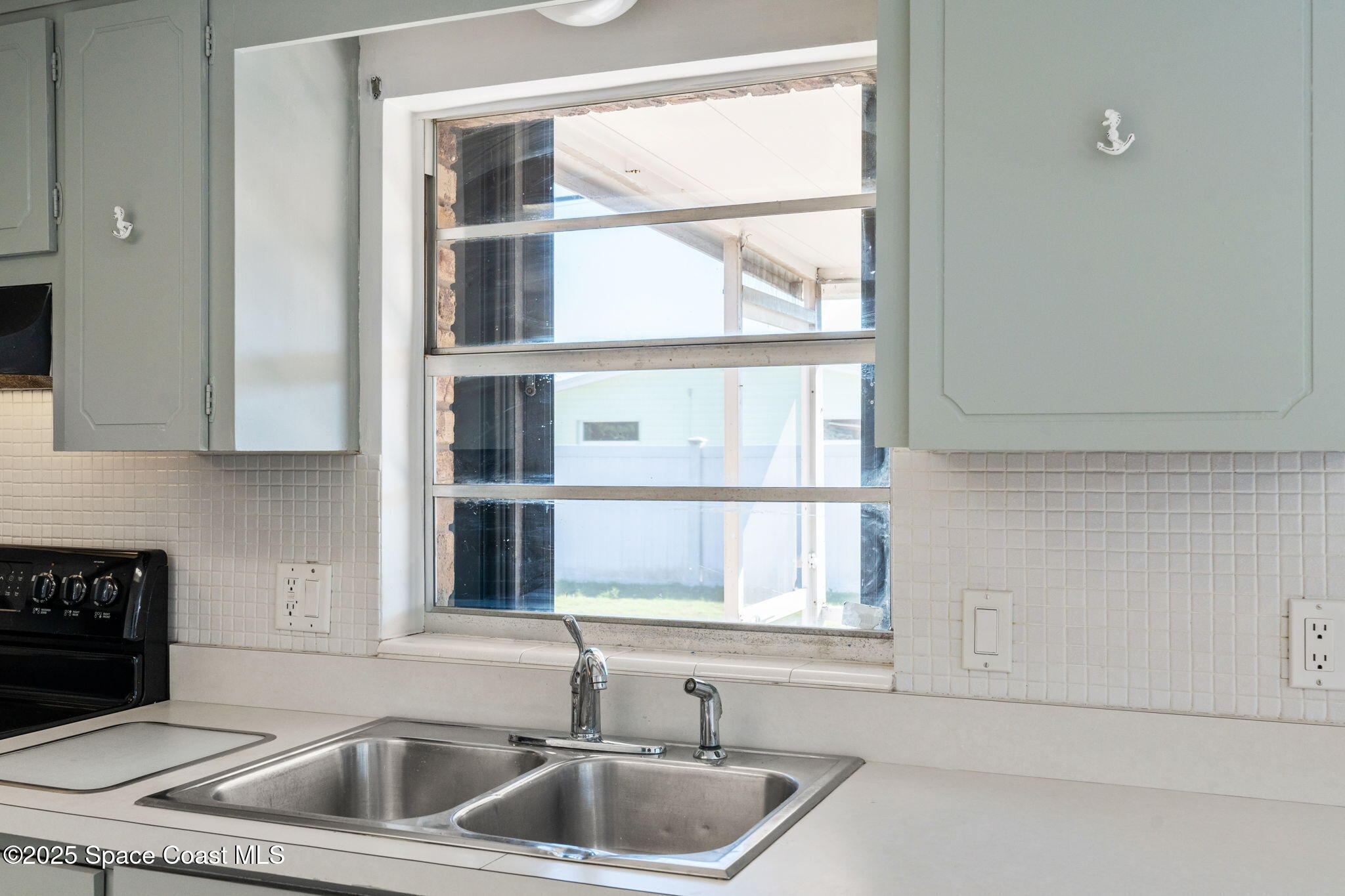 2361 Colony Drive Melbourne, FL 32935 - Photo 26 of 40 a kitchen with a sink and a window