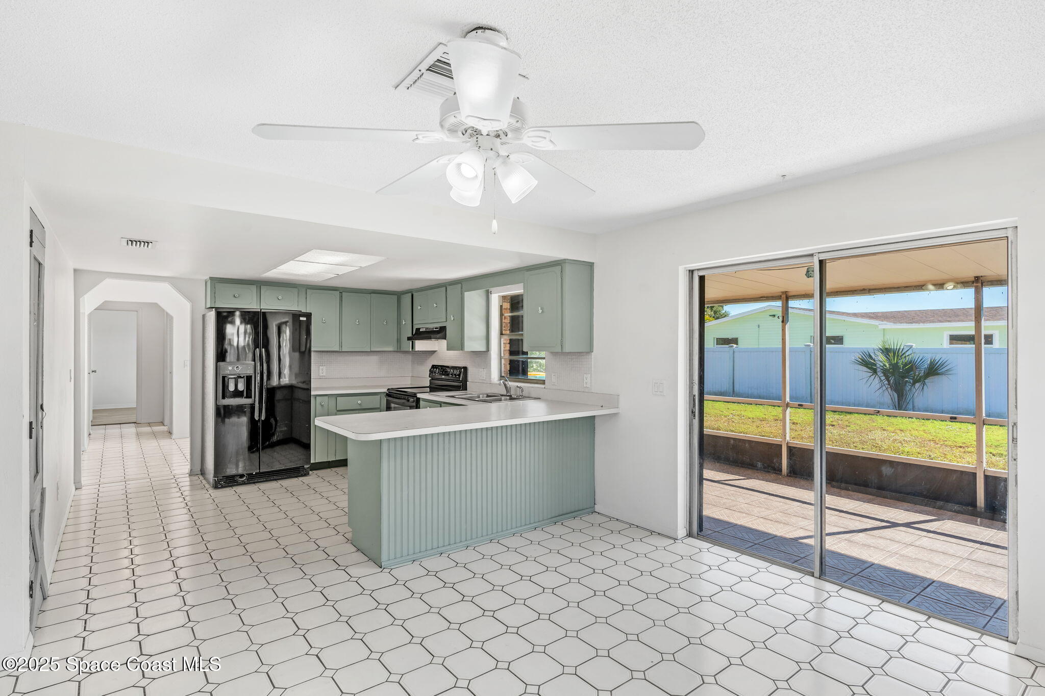 2361 Colony Drive Melbourne, FL 32935 - Photo 27 of 40 a kitchen with stainless steel appliances granite countertop a refrigerator and a sink
