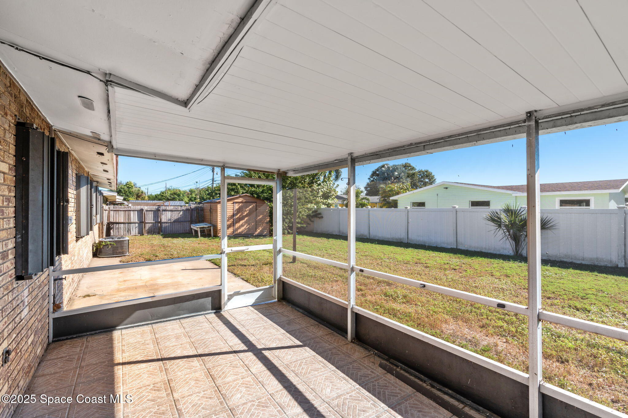 2361 Colony Drive Melbourne, FL 32935 - Photo 33 of 40 a view of a large room with wooden floor and windows