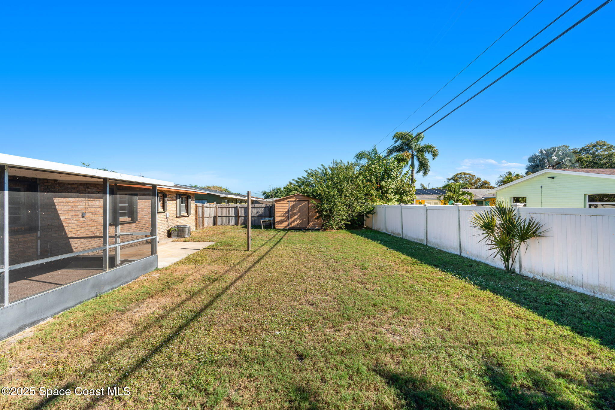 2361 Colony Drive Melbourne, FL 32935 - Photo 35 of 40 a swimming pool with yard and wooden fence