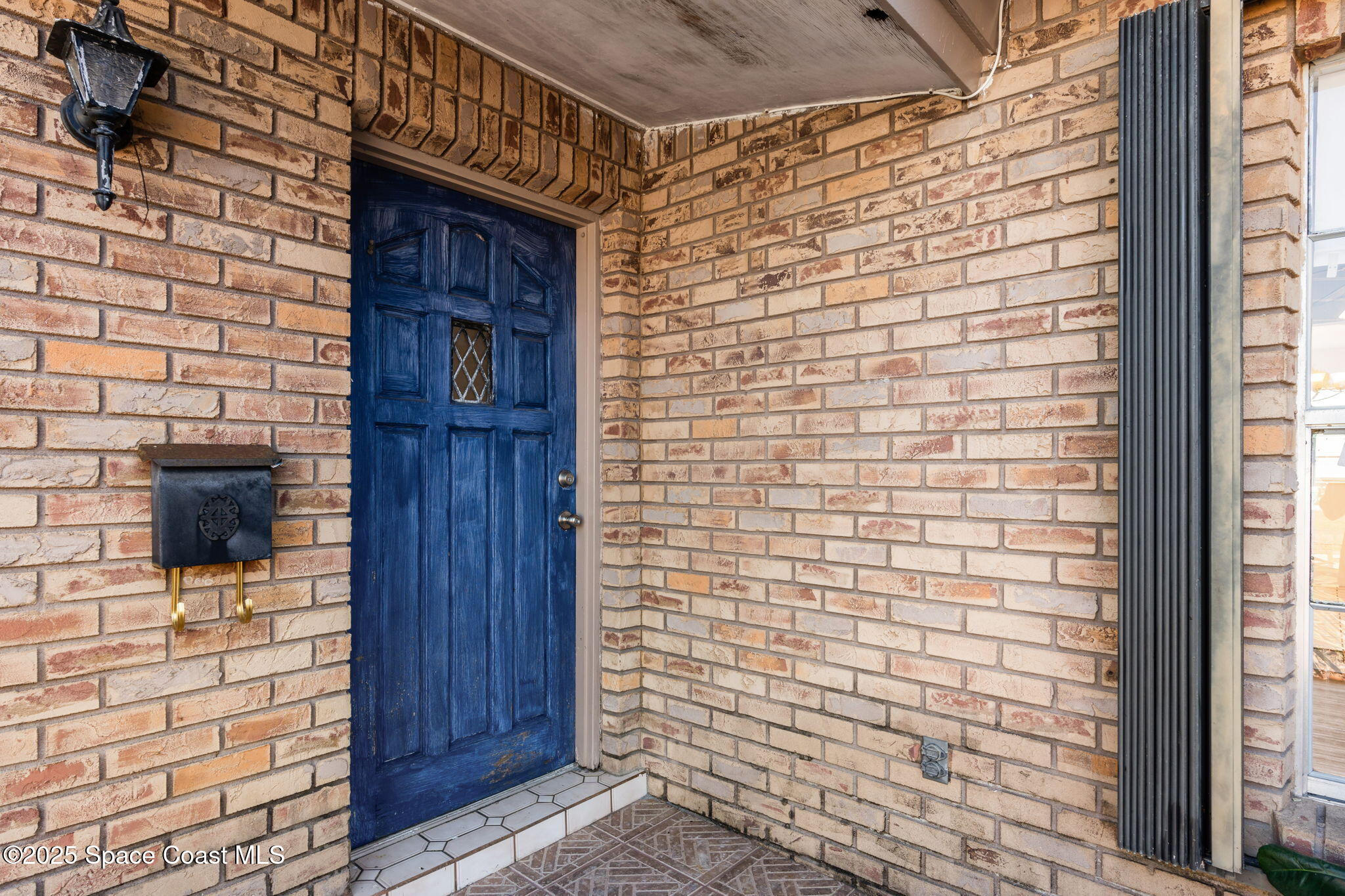 2361 Colony Drive Melbourne, FL 32935 - Photo 4 of 40 a brick house with a street
