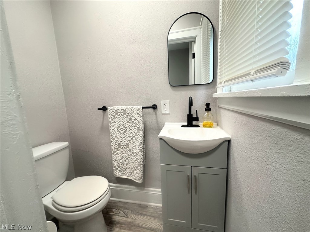3409 Cedarbrook Road Cleveland Heights, OH 44118 - Photo 9 of 16 Bathroom with a textured wall, vanity, and dark wood-style flooring