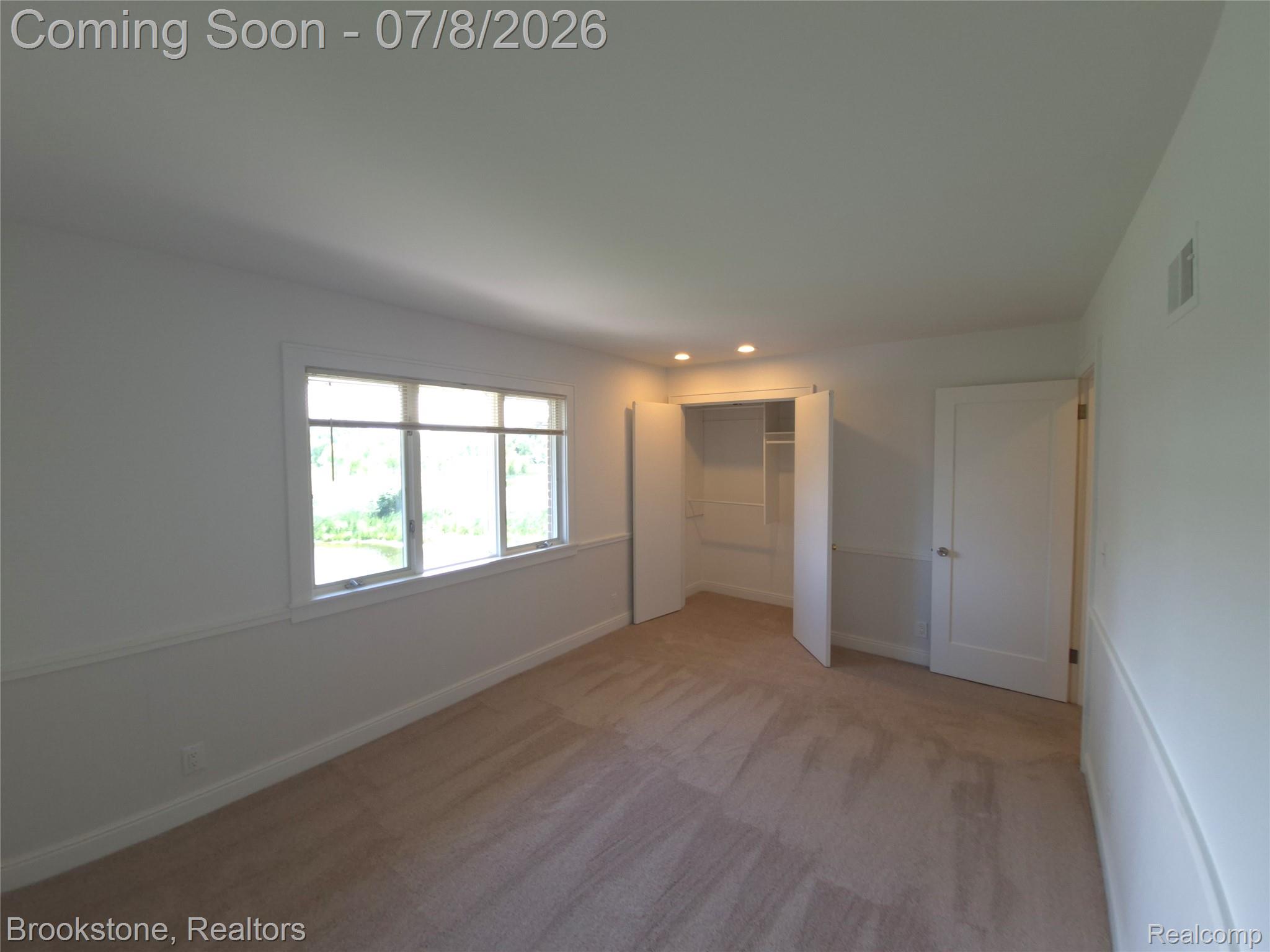 4140 South Henderson Road Davison, MI 48423 - Photo 56 of 98 Carpeted room with a multi-pane window, built-in closet with shelves, recessed lighting, and a solid panel door