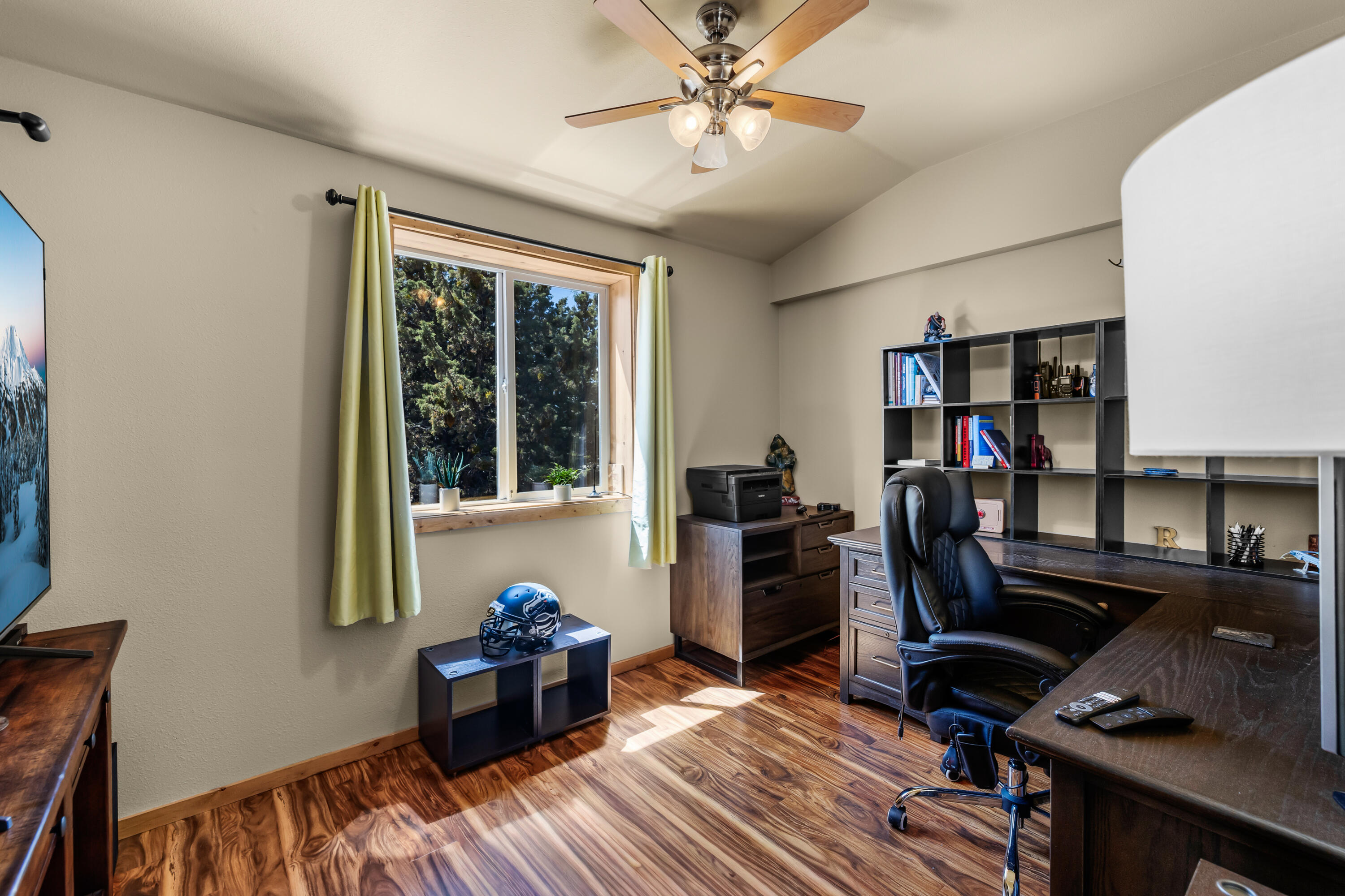 64145 Hunnell Road Bend, OR 97703 - Photo 57 of 65 One of three separate rooms within the upper-level guest/flex quarters is currently used as an office, offering natural light and flexible space for work, guests, hobbies or creative use.