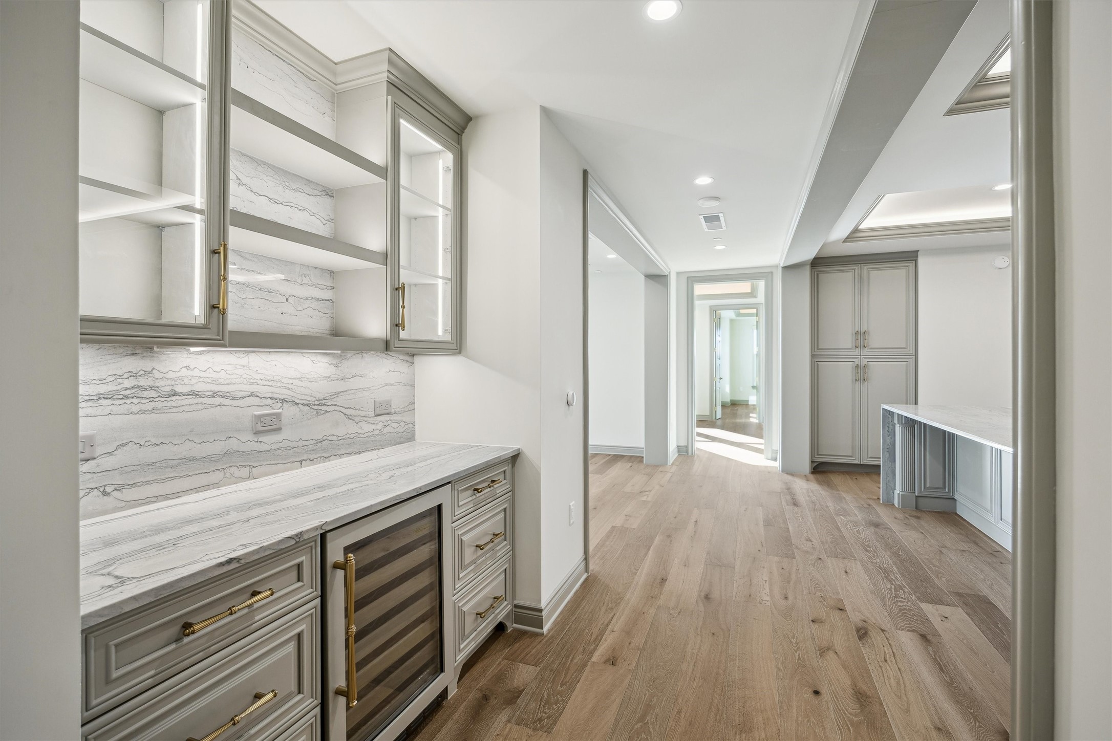 1717 Bissonnet Street, Unit 1106 Houston, TX 77005 - Photo 9 of 35 a kitchen with a sink and wooden floor
