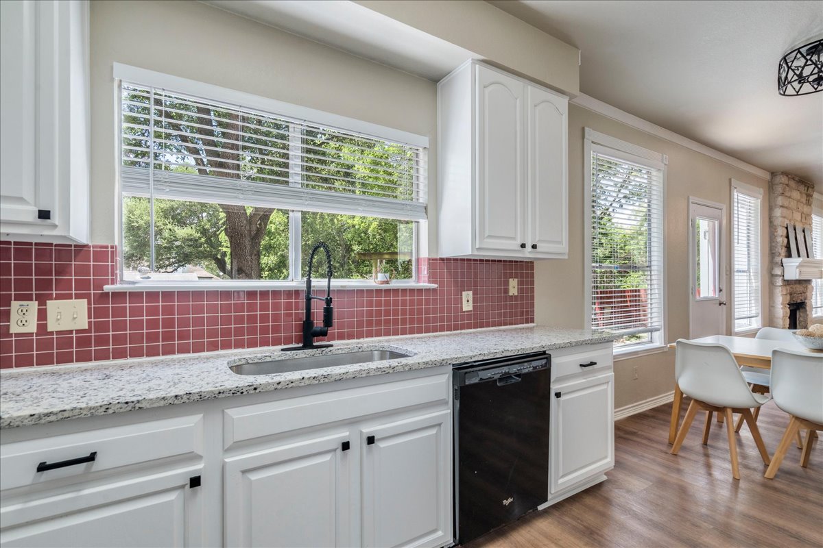 9300 Tea Rose Trail Austin, TX 78748 - Photo 13 of 33 Well-lit kitchen with granite countertops and a large window offering garden views.
