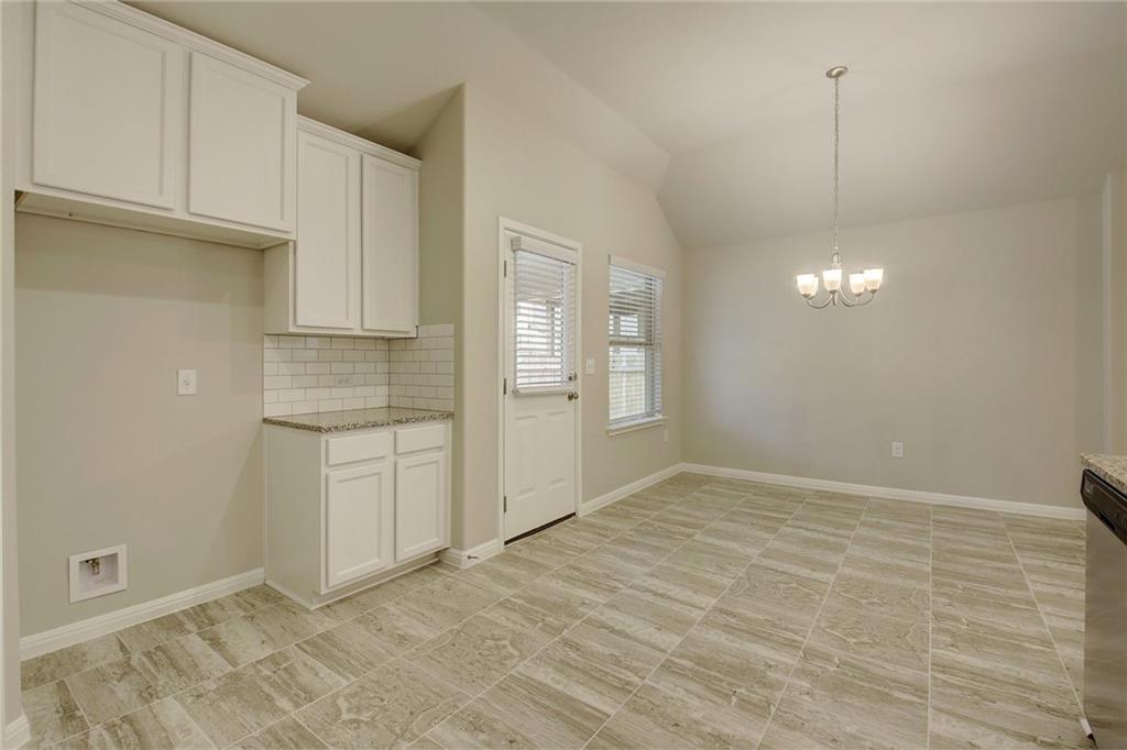 13216 Mariscan Street Manchaca, TX 78652 - Photo 9 of 28 Unfurnished dining area featuring vaulted ceiling and hanging lights