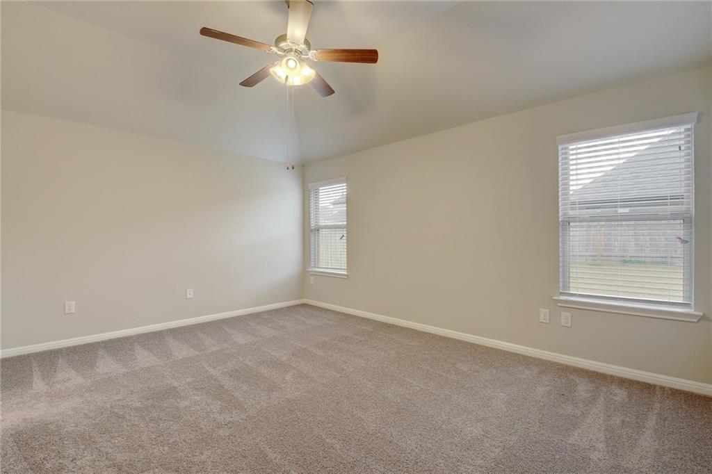 13216 Mariscan Street Manchaca, TX 78652 - Photo 10 of 28 Spare room with plenty of natural light, light colored carpet, a ceiling fan, and lofted ceiling