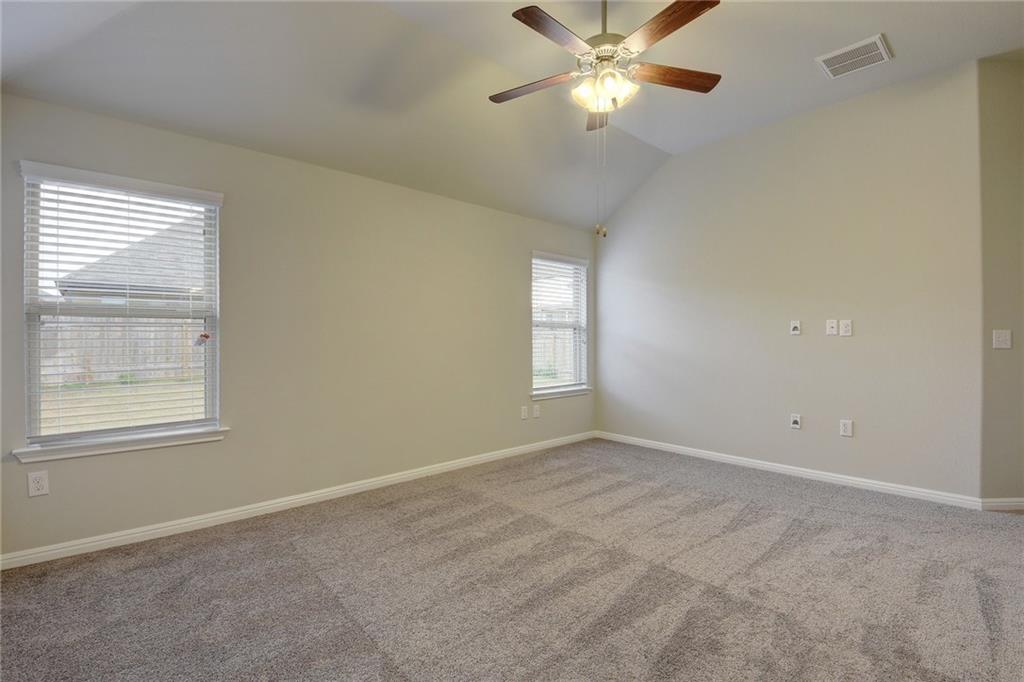 13216 Mariscan Street Manchaca, TX 78652 - Photo 11 of 28 Carpeted spare room featuring vaulted ceiling and ceiling fan