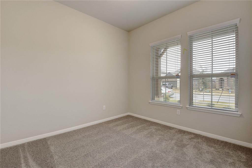 13216 Mariscan Street Manchaca, TX 78652 - Photo 13 of 28 Empty room with baseboards and light colored carpet