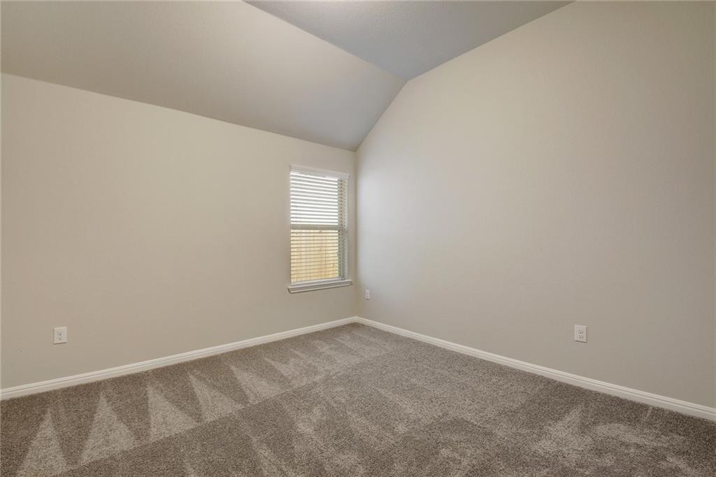 13216 Mariscan Street Manchaca, TX 78652 - Photo 14 of 28 Unfurnished room with lofted ceiling and carpet floors
