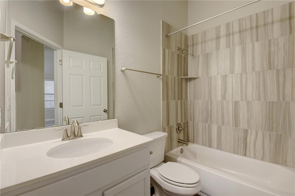 13216 Mariscan Street Manchaca, TX 78652 - Photo 15 of 28 Full bath with a textured wall, shower / washtub combination, and vanity