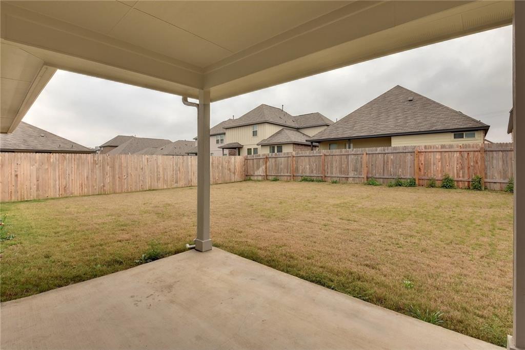 13216 Mariscan Street Manchaca, TX 78652 - Photo 17 of 28 Fenced backyard featuring a patio