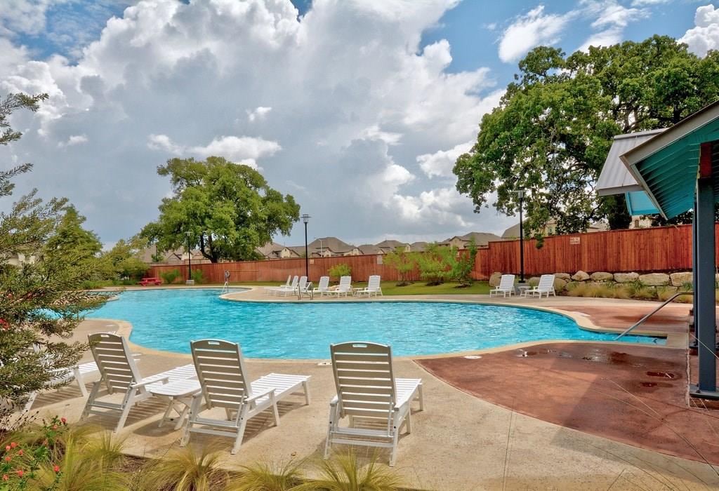 13216 Mariscan Street Manchaca, TX 78652 - Photo 22 of 28 Community pool with a patio area