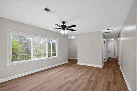 a view of an empty room with wooden floor