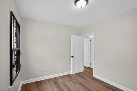 a kitchen with granite countertop a stove top oven sink and cabinets
