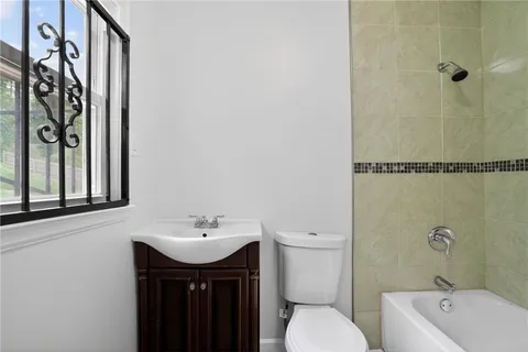 a room with white cabinets and wooden floor
