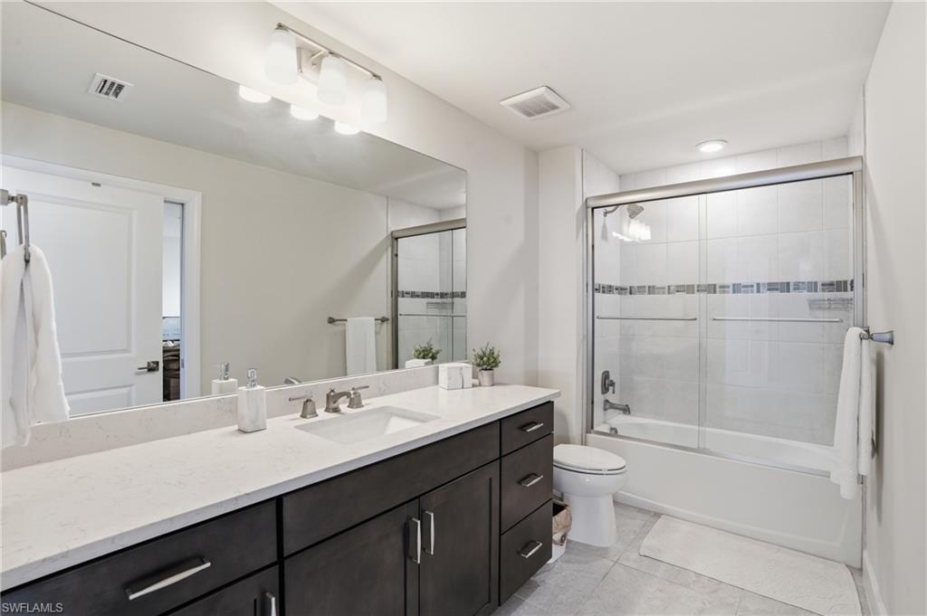 19696 Aqua View Lane Fort Myers, FL 33913 - Photo 30 of 50 a bathroom with a double vanity sink toilet mirror and shower