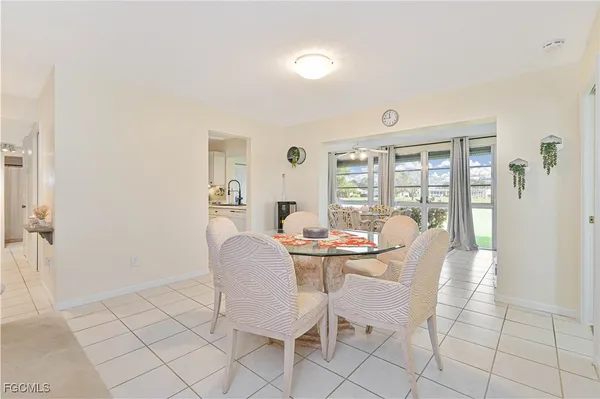 a dining room with furniture and a kitchen view