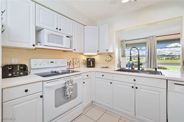 a view of kitchen with a sink and cabinets