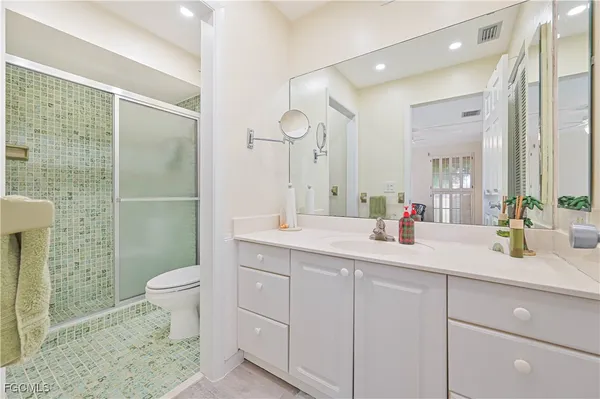 a white toilet sitting next to a bathroom shower