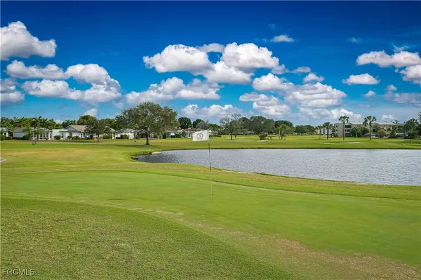 a view of a hallway with wooden floor and a dining room