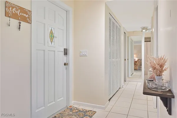 a living room with furniture a table and kitchen view