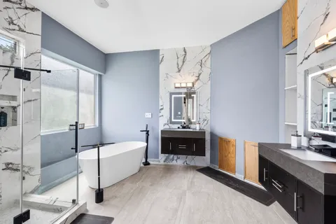 a spacious bedroom with a bed and a dresser
