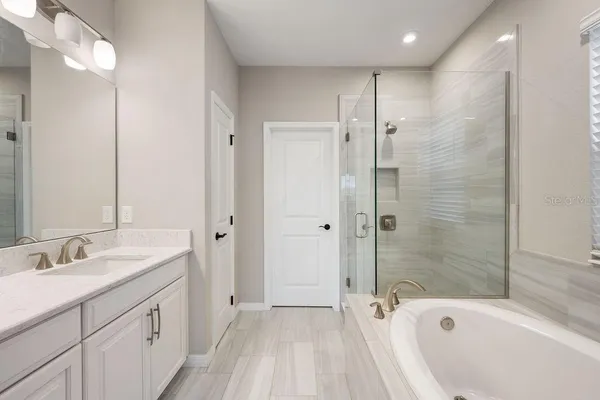 a bathroom with double vanity sinks and a mirror