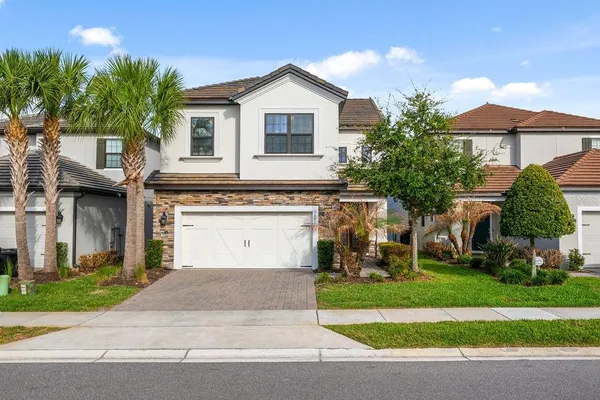 a front view of a house with a yard and garage