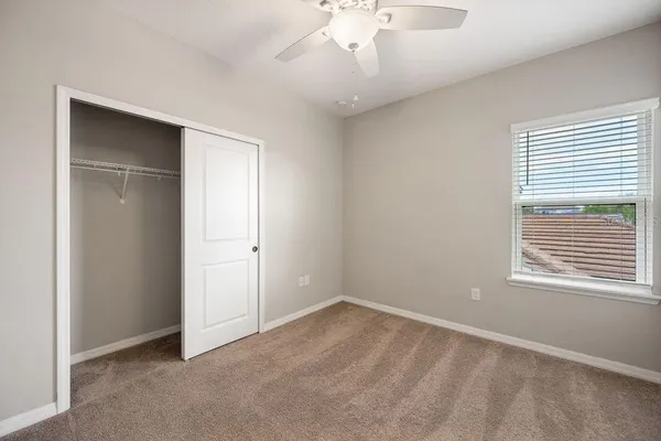 a bathroom with a granite countertop sink a toilet and a mirror