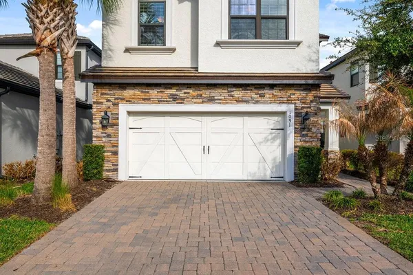 a front view of a house with a yard and garage