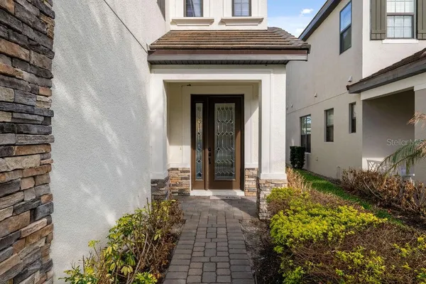 a view of a house with potted plants