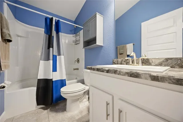 a bathroom with a sink a toilet and a shower