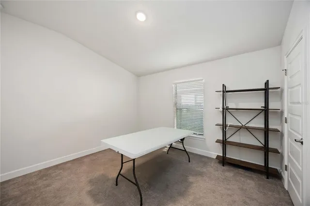 a view of a room with a table and chairs