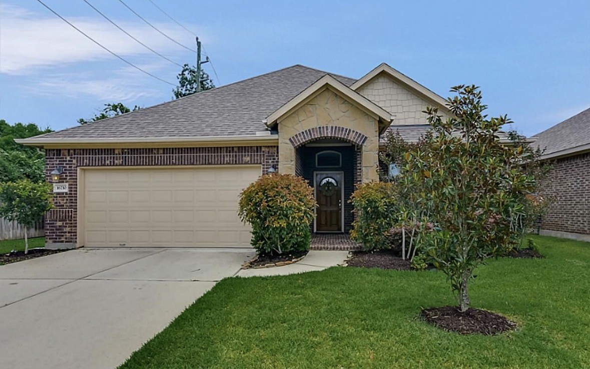 a front view of a house with garden