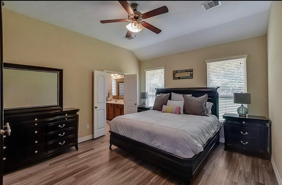 16710 Dover Mills Drive Spring, TX 77379 - Photo 11 of 15 a bedroom with a bed and a flat tv screen on dresser