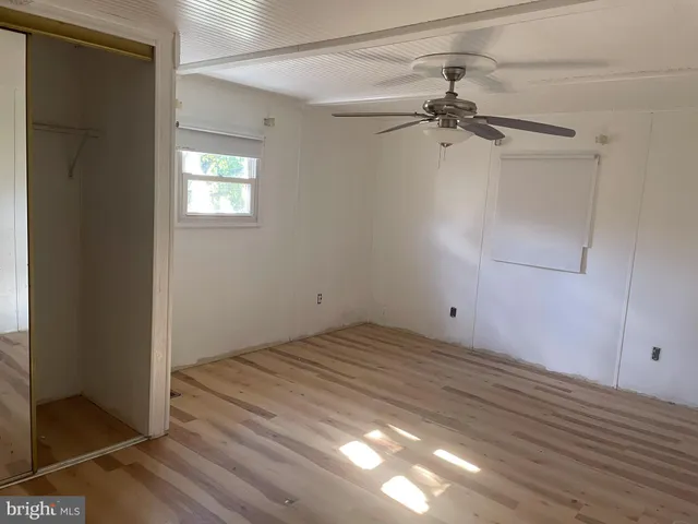 a view of a room with a fan and a ceiling fan