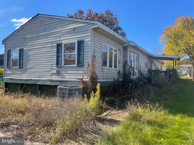 a view of a house with a yard from a lake view