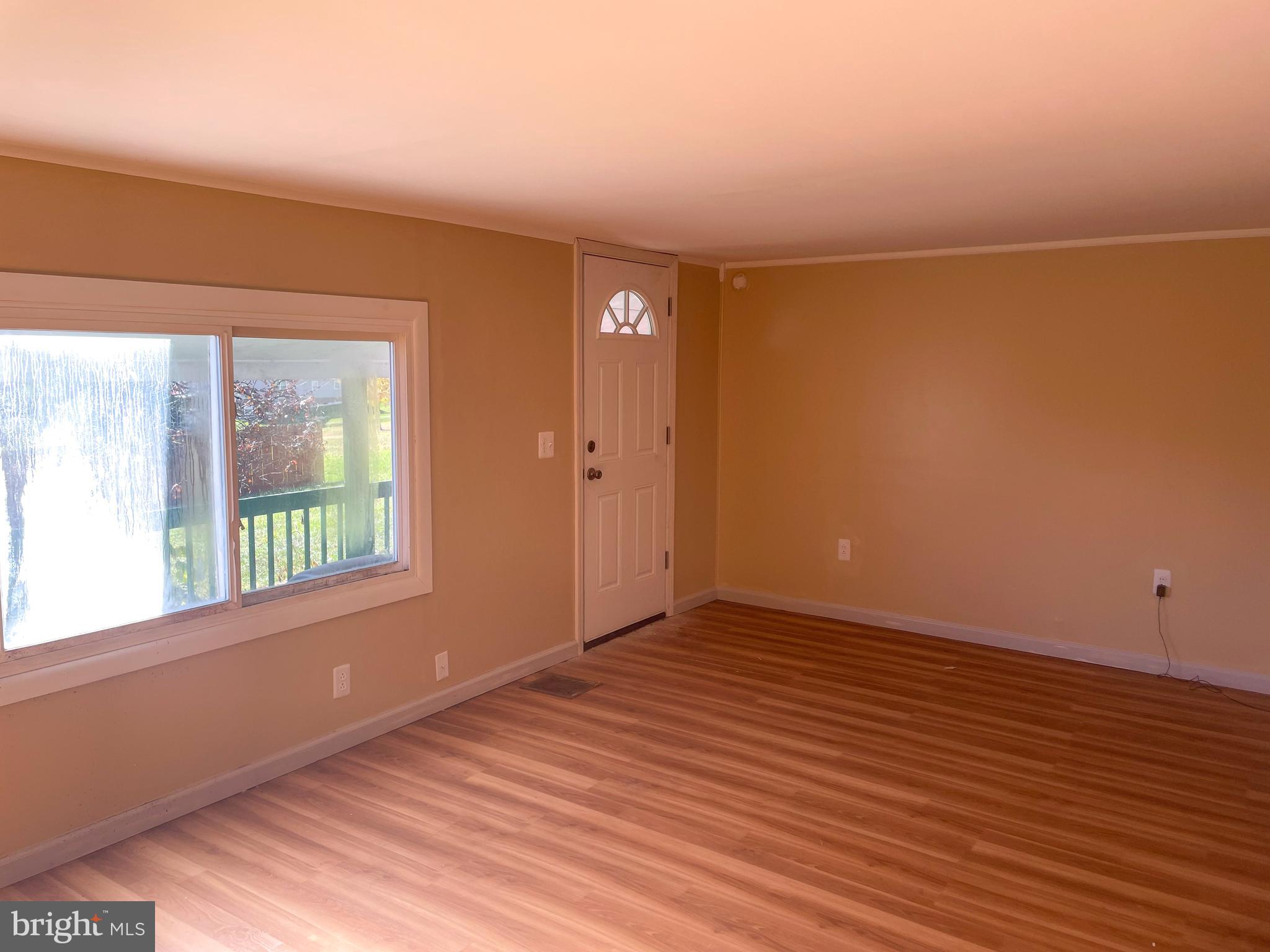 161 Pepple Road East Freedom, PA 16637 - Photo 8 of 14 an empty room with wooden floor and windows