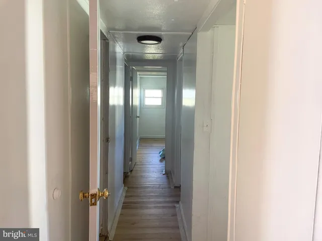 a view of a room with wooden floor closet and windows