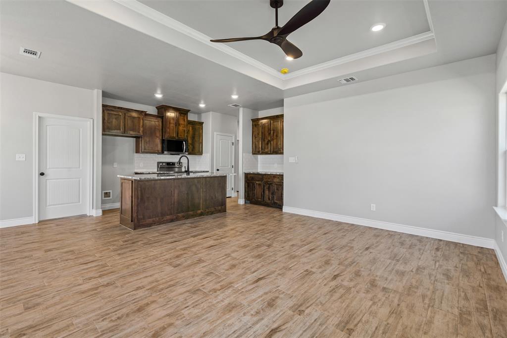 3400 Hilltop Road Granbury, TX 76048 - Photo 14 of 40 a view of a kitchen with a sink cabinets and wooden floor