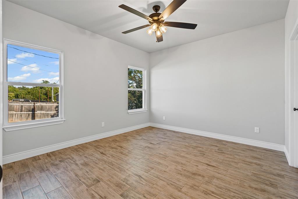 3400 Hilltop Road Granbury, TX 76048 - Photo 23 of 40 wooden floor in an empty room with a window